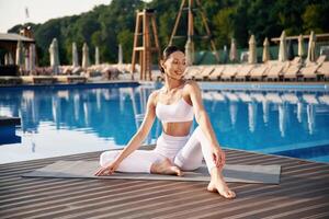 Resting,, taking a,, break. Fitness woman is near the pool photo