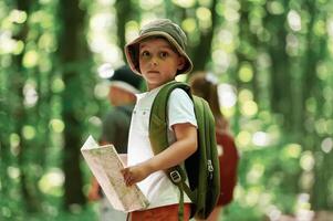 Kids in forest at summer daytime together photo