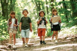 Walking ,together. Kids ,in forest at summer daytime photo