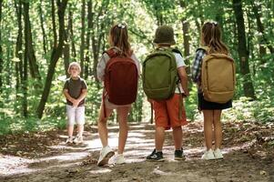 Little tourists.. Kids in forest at summer daytime together photo