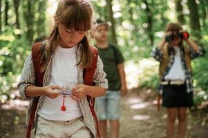 Little, tourists. Kids in forest at summer daytime together photo