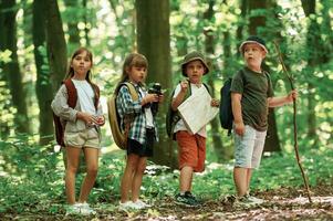 Discovering new, place. Kids in forest at summer daytime together photo