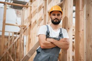 In yellow,hardhat. Industrial worker,, in ,wooden warehouse photo