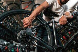 Adjusting the, wheel... Repair ,man in bicycle shop, working in store photo
