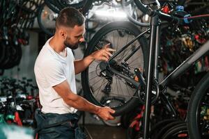 Working in the store. ,,Repair man in bicycle shop photo