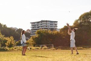 Side view... Man with ,woman are playing badminton on the field photo