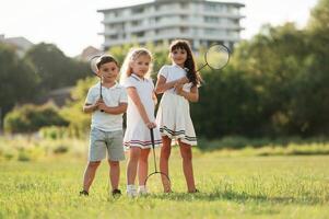 Happy kids are on the summer field. photo