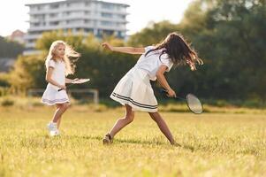 Game, of, badminton. Happy, kids are on the summer field photo