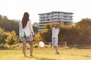 Conception, of sports ,,and hobby. Man with woman are playing badminton on the field photo