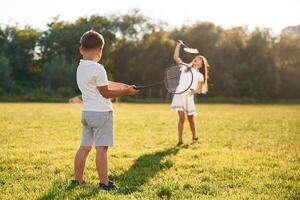 Happy kids,, are on the summer field photo