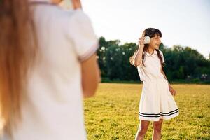 Fun, with tin can phone.. Happy kids are on the summer field photo