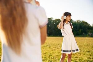 Fun, with, tin, can phone. Happy kids are on the summer field photo