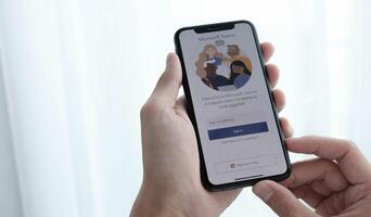 CHIANG MAI, THAILAND - APR 11, 2021 . A working from home employee is downloading the Microsoft Teams social platform, ready for remote working in isolation from home photo