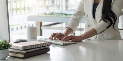 Close up of businesswoman or accountant working keyboard financial data report, accountancy document and laptop computer at office, business concept photo