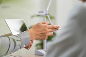 ESG Consultation. Professional discussing sustainable business practices with client. photo