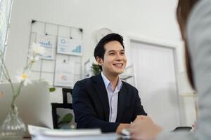 Positive Business Interaction. Consultant smiling while engaging with a client in a meeting. photo