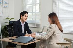 Positive Financial Interaction. Colleagues sharing insights in a vibrant office. photo