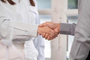 Business Agreement. Close-up of a handshake between two professionals in a bright office. photo
