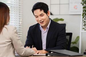 Financial Engagement and Strategy Discussion. Business professional taking notes during a financial meeting. photo