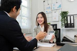 Positive Financial Consultation. Smiling financial advisor presenting financial solutions to a client. photo