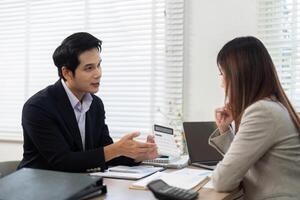 Financial Consultation Session. Advisor presenting financial data and strategies to a client. photo