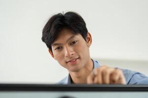 Engaged Professional Analyzing Data. Young man focused on presenting information on a digital board. photo