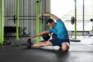 Fitness and Flexibility. Man stretching in a gym for improved mobility. photo