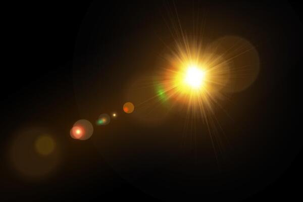 A bright light shining on a black background