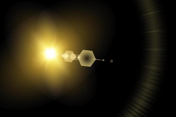 A yellow light is shining on a black background