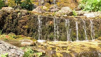 Waterfall, Rocks, Stream, Cascading water flows over rocks and into a stream. video