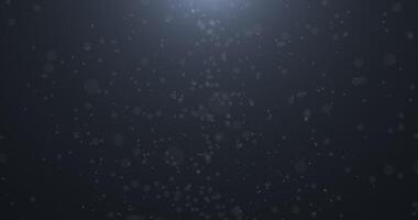 Slowly falling, swirling, and sparkling bokeh particles in white light against a dark background. Abstract snow.1 video