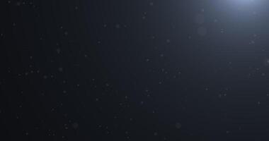Slowly falling, swirling, and sparkling bokeh particles in white light against a dark background. Abstract snow.31 video