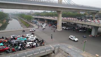 Aerial view of chaotic traffic at major intersection in Hanoi, Vietnam, with motorbikes, cars, and flyovers. Ideal for transport, urban life, and infrastructure in Southeast Asia themes. video