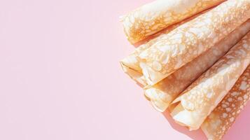 A stack of pancakes on a pink background photo