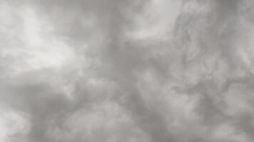 Thick, dark gray clouds covering the sky, signaling heavy rain or storm. A common weather scene during monsoon season, creating a moody and dramatic sky background. photo