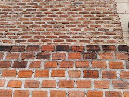 a brick wall with a sign on it photo
