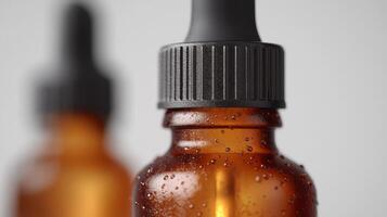 a bottle of essential oil is shown with droplets on it photo