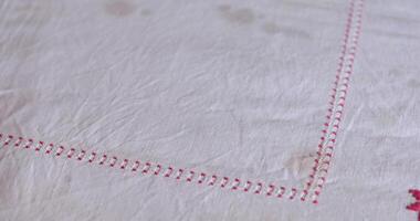 Cottagecore aesthetic comes alive with vintage tablecloth featuring intricate embroidery and folk motifs. Old fabrics with dirty spots. Tablecloth countryside style that enhances any rustic setting. video