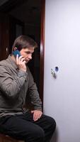 man sitting on a chair talking on a cell phone video