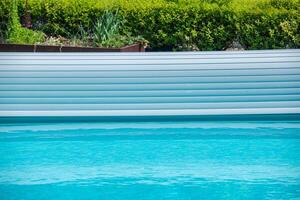 Relaxing Summer Day at a Tranquil Backyard Pool. Plastic Surface Cover photo