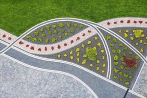 Colorful Garden Design Showcasing Curved Flower Beds and Patterned Pathways in a Park Setting photo