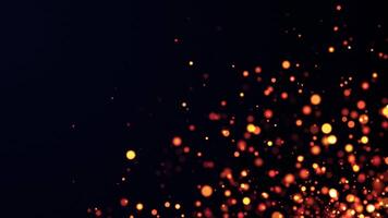 Abstract golden particles animation concept for birthday and holiday celebrations or sparks from a bonfire. 4k loop bokeh background with light particles and stars falling on a dark background video