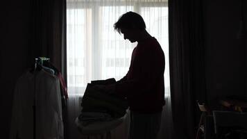 A man is standing in front of a window with a suitcase video