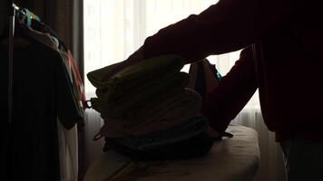 A person is standing in front of a pile of clothes video