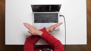 A person sitting at a table with their hands up video