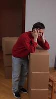 A man is standing in front of a pile of boxes video
