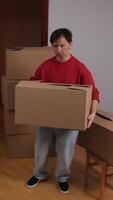 A man carrying boxes in an empty room video