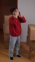 A man standing in front of boxes with his hands on his face video