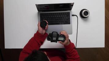 A person using a camera to take pictures of a laptop video
