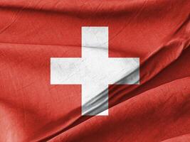 Waved Textured Arafed image of a swiss flag with a white cross on it photo